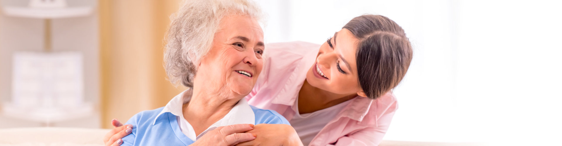 caregiver and a senior smiling